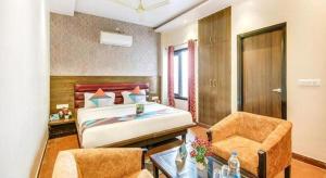 a bedroom with a bed and a desk and a chair at King Heritage in Lucknow