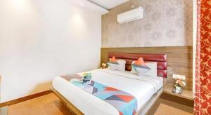 a bedroom with a large bed with a glass table at King Heritage in Lucknow