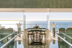 a table in a room with a view of the ocean at Hotel Cascais Miragem Health & Spa in Cascais
