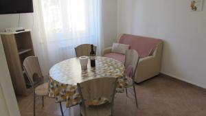 a small room with a table and chairs and a couch at Apartments Furlan in Portorož