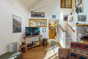 a living room with a television and a fireplace at Circle 4 Ranch 31 | Discover Sunriver in Sunriver
