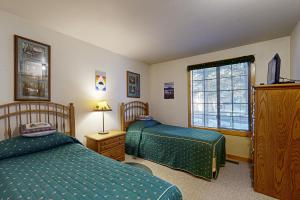 a bedroom with two beds and a window at Circle 4 Ranch 31 | Discover Sunriver in Sunriver +26 photos