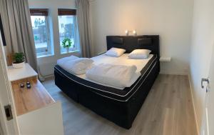 a bedroom with a large bed with white pillows at Newly renovated, near town center in Grebbestad