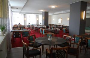 a dining room filled with tables and chairs at Hotel Hirvi in Äänekoski