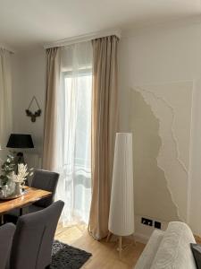 a living room with a table and a window at Kaiserhof Apartment 14 in Wangerooge +6 photos
