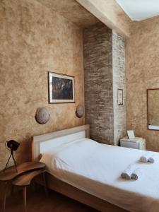 a bedroom with a large white bed with a table at Tartana 1 in Dobrota