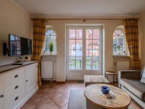 a living room with a couch and a table at Landhaus St Niels in Westerland (Sylt)