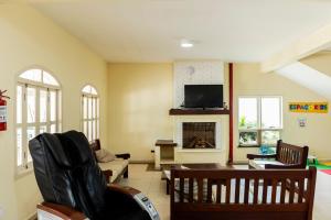 a living room with a couch and a fireplace at Pousada Porto do Rio in Caraguatatuba