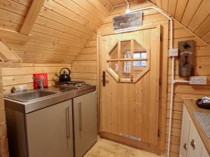 a kitchen with a sink and a stove in a cabin at Enchanted Cottage in Snettisham +9 photos