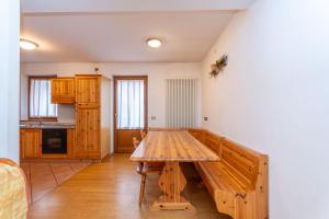 a kitchen with a wooden table in a room at Villa Eden in Falcade