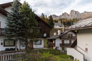 a group of buildings with mountains in the background at Villa Eden in Falcade