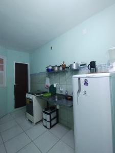 a small kitchen with a sink and a refrigerator at Apartamento Favo de Mel 2 in Madre de Deus