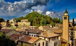 a view of a town with houses and a tower at Locanda Alla Posta in Cavaso del Tomba
