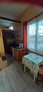 a small kitchen with a table and a window at Tiny House lumineuse et ressourçant in Le Brusquet +10 photos