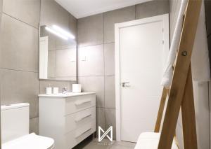 un bagno con un water, un lavandino e uno specchio di MyStay - Casa Pedrosa a Valença Altre 8 foto