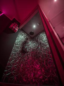 a room with pink and purple lighting and a ceiling at Shiny Cloud Love Room in Limoux