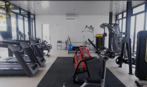 a gym with several treadmills and cardio machines at Meisterstad Pollux Habibie Apartment Batam Studio805 in Batam Center