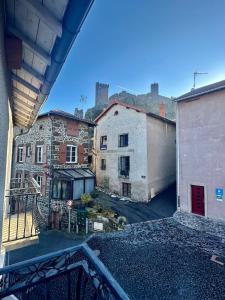 a view of a city from a balcony at Maison de bourg près du château in Polignac