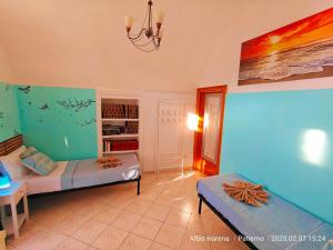 a bedroom with two beds and a book shelf at Manù Apartment in Vico Equense