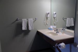 a bathroom with a sink and a mirror and towels at 2 Bedroom accessible condo in Eagle River