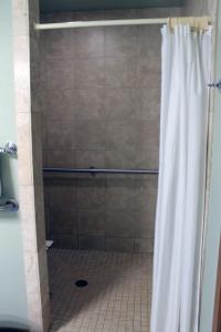 a shower with a white shower curtain in a bathroom at 2 Bedroom accessible condo in Eagle River +29 photos