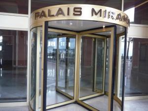 a revolving door in a building with a sign on it at Residence Palais Miramar in Cannes