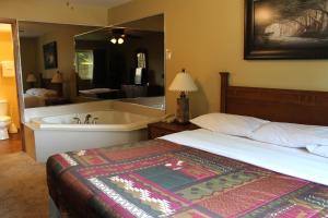 a bedroom with a bed and a bath tub at 2 Bedroom Condo at Wild Eagle Lodge in Eagle River