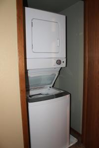a microwave sitting on top of a refrigerator at 2 Bedroom Condo at Wild Eagle Lodge in Eagle River