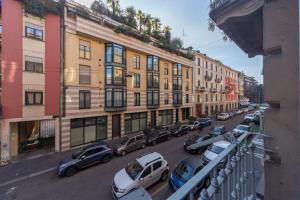 a city street with cars parked in front of buildings at Cozy Apartment Porta Venezia in Milan