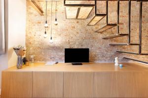 an office with a desk with a tv on top of it at Dezza Loft in Milan