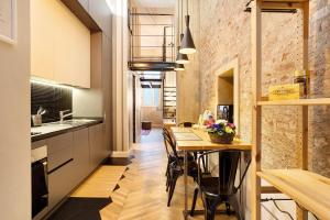 a kitchen with a table and chairs in a room at Dezza Loft in Milan