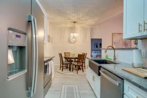 a kitchen with a sink and a table at 9 Mi to Dtwn Fayetteville Condo with Pool Access! in Hope Mills