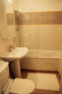 a bathroom with a sink and a toilet and a tub at Domaine De Chantemerles in Fontainebleau +74 photos