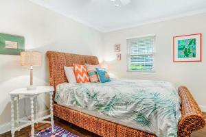 a bedroom with a bed and a table with a lamp at 96097 Piney Island in Fernandina Beach