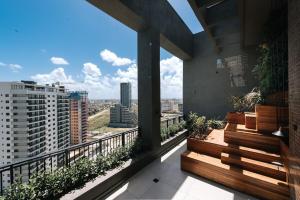 a balcony with benches and a view of a city at Loft 613 Canto com garagem in Pelotas