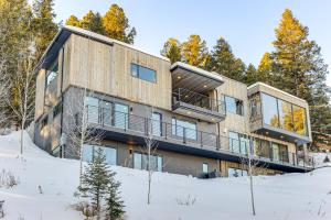 a house on top of a snow covered slope at 1 Mi to Downtown Jackson Modern Retreat with Views in Jackson