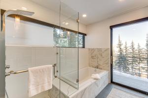 a bathroom with a shower and a tub and a window at 1 Mi to Downtown Jackson Modern Retreat with Views in Jackson +35 photos
