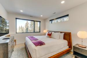 a bedroom with a large bed and two windows at 1 Mi to Downtown Jackson Modern Retreat with Views in Jackson