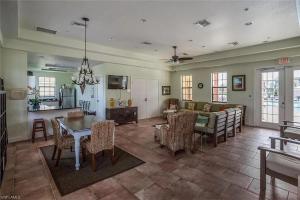 a living room with a couch and a table and chairs at Condo Near the Beach in Fort Myers