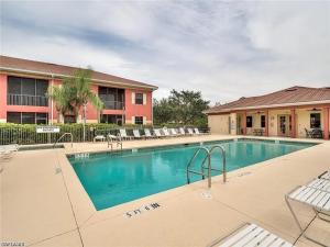 a swimming pool in front of a building at Condo Near the Beach in Fort Myers