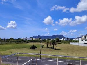 a view of a street with a field and buildings at Modern Retreat - Comfort & Style in Hermitage