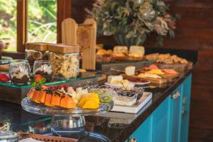 a buffet with many different types of food on display at Valle Ristretto - Exclusivo para Casais in Gramado