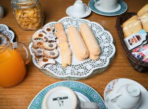 a table with a plate of hot dogs and pastries at L Agrifoglio di Rita Loddo in Fonni