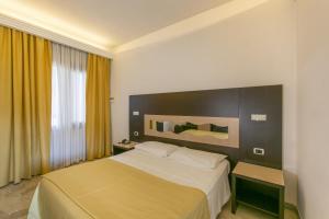Postel nebo postele na pokoji v ubytování Hotel Boomerang Roma