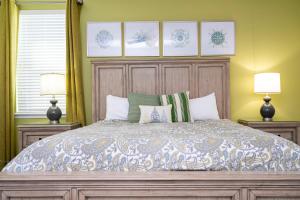 a bedroom with a large bed with two lamps at 510 BS - 5BD Cozy Family Haven with Pool in Orlando