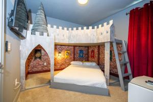 a bedroom with a castle bunk bed with a ladder at 510 BS - 5BD Cozy Family Haven with Pool in Orlando