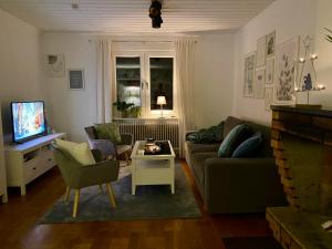 a living room with a couch and a table at FoRest House in Rosenfors