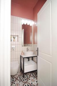 a bathroom with a sink and a toilet and a mirror at Space AB central in Kalamata +14 photos