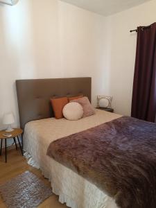 a bedroom with a large bed with orange pillows at Casinha da Vila in Arcos de Valdevez