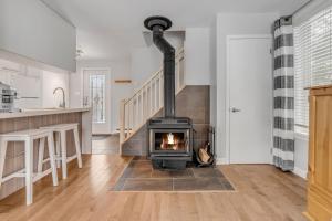 a fireplace in a living room with a staircase at Initial / Renard / MSA in Beaupré